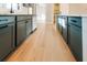 Contemporary kitchen features gray cabinets, white countertops, and wood flooring, offering a sleek design at 143 Harvest Way, Walterboro, SC 29488