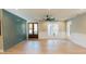 Bright living room featuring wood flooring, shiplap accent wall, ceiling fan, and natural light from large windows at 143 Harvest Way, Walterboro, SC 29488