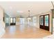 Spacious, light-filled living room with wood floors, recessed lighting, and French doors with scenic views at 143 Harvest Way, Walterboro, SC 29488