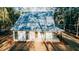 Stylish home exterior featuring a metal roof, covered porch with wood columns, and verdant surroundings at 143 Harvest Way, Walterboro, SC 29488