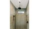 Modern tiled shower with sleek fixtures, shower niche and a window providing natural light at 143 Harvest Way, Walterboro, SC 29488