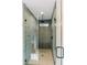 Contemporary shower with glass enclosure showcases gray tiled walls, rain shower head, and mosaic tiled floor at 143 Harvest Way, Walterboro, SC 29488