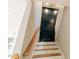 Stylish staircase with wooden railing leading to a dark accent wall at 143 Harvest Way, Walterboro, SC 29488