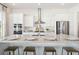 Modern kitchen featuring a large island with seating, white cabinetry, and stainless steel appliances at 1437 Clayfield Trl, Summerville, SC 29485