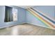 Bedroom with light blue walls, colorful painted accent and wood-look floors at 1481 Center Street Ext # 601, Mount Pleasant, SC 29464