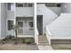 Close up of the exterior of a condo unit, showcasing the stairs and small palm tree at 1481 Center Street Ext # 601, Mount Pleasant, SC 29464