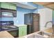 Kitchen features appliances, and green cabinets at 1481 Center Street Ext # 601, Mount Pleasant, SC 29464