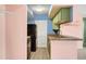 Galley kitchen features green cabinets, a breakfast bar, and a black refrigerator at 1481 Center Street Ext # 601, Mount Pleasant, SC 29464
