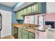 Kitchen has green cabinets, and opens to the living room at 1481 Center Street Ext # 601, Mount Pleasant, SC 29464