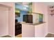 Cozy kitchen features a breakfast bar, and black appliances at 1481 Center Street Ext # 601, Mount Pleasant, SC 29464