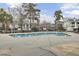 Community pool features multiple lounge chairs and is surrounded by mature trees at 1481 Center Street Ext # 601, Mount Pleasant, SC 29464