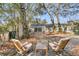 Outdoor space with a cozy seating area on a brick patio, surrounded by lush trees at 1521 Lynton Ave, Charleston, SC 29412