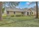 Back view of property with a well-manicured lawn and partial tree coverage at 158 Commons Way, Goose Creek, SC 29445