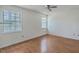 This airy bedroom features gleaming hardwood floors and lots of natural light from the double-paned windows at 158 Commons Way, Goose Creek, SC 29445