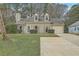 Charming home with manicured lawn, dormer windows, attached garage, and an extra long driveway at 158 Commons Way, Goose Creek, SC 29445