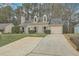 Charming home with manicured lawn, dormer windows, attached garage, and an extra long driveway at 158 Commons Way, Goose Creek, SC 29445