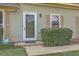Front entrance featuring a glass door, small porch, and manicured landscaping at 158 Commons Way, Goose Creek, SC 29445