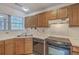 The kitchen features a stainless steel sink, dark appliances, and laminated countertop at 158 Commons Way, Goose Creek, SC 29445