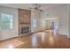 Bright living room features a brick fireplace, hardwood floors, and ample natural light at 158 Commons Way, Goose Creek, SC 29445