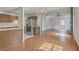 Open living room and kitchen with hardwood floors and stainless steel appliances at 158 Commons Way, Goose Creek, SC 29445