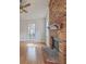 Cozy living room with hardwood floors, a ceiling fan, and a large brick fireplace at 158 Commons Way, Goose Creek, SC 29445