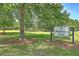 Scenic view of Middleton Park, featuring lush green grass, mature trees, and a welcoming sign at 158 Commons Way, Goose Creek, SC 29445