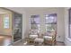 Sunroom with wicker furniture offers a view of the backyard through large windows at 158 Commons Way, Goose Creek, SC 29445