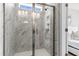 Luxurious walk-in shower with elegant marble tile, built-in niche, and sleek glass enclosure at 159 Cantona Dr, Summerville, SC 29483