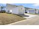 White detached garage with a concrete driveway surrounded by a well-kept lawn at 161 Cantona Dr, Summerville, SC 29483
