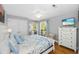 Inviting bedroom with balcony access, dresser, and nautical themed accents at 1638 Live Oak Park, Seabrook Island, SC 29455