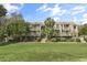 Beautiful view of the condominium building with a well-manicured lawn and lush landscaping at 1638 Live Oak Park, Seabrook Island, SC 29455