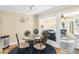 Charming dining area with glass table, stylish chairs, and adjacent sunroom at 1638 Live Oak Park, Seabrook Island, SC 29455