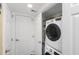 Efficient laundry closet featuring stacked washer and dryer unit and some storage shelves at 1638 Live Oak Park, Seabrook Island, SC 29455