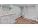 Clean bathroom with white vanity, round mirror, and a combined tub and shower, perfect for relaxation at 1657 Short Cut Rd, Cross, SC 29436