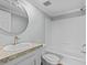 This bathroom features a round mirror, vanity with countertop, and a shower-tub combo at 1657 Short Cut Rd, Cross, SC 29436