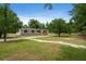 Spacious front yard with mature trees surrounding a cozy, single-story home at 1657 Short Cut Rd, Cross, SC 29436