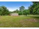 Wide shot of a home situated on a spacious lot surrounded by trees at 1657 Short Cut Rd, Cross, SC 29436