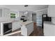 Well-lit kitchen with white cabinets, stainless steel appliances, and an island with a granite countertop at 1657 Short Cut Rd, Cross, SC 29436