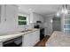 Bright kitchen with white cabinetry, granite countertops, a central island, and stainless steel appliances at 1657 Short Cut Rd, Cross, SC 29436