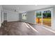 Open-concept living room with wood-look flooring and sliding glass doors leading to an outdoor deck at 1657 Short Cut Rd, Cross, SC 29436