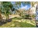 Beautiful backyard with lush green grass, a pathway, and mature trees that provide ample shade at 172 Mary Ellen Dr, Charleston, SC 29403