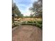 Serene brick-paved backyard patio with beautiful marsh views, lush greenery, and charming decorative lighting at 172 Mary Ellen Dr, Charleston, SC 29403
