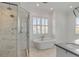 Elegant bathroom with a glass-enclosed shower, soaking tub, and bright natural light at 172 Mary Ellen Dr, Charleston, SC 29403