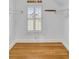 Walk-in closet showcases hardwood floors, custom shelving, hanging rods, and a large window with plantation shutters at 172 Mary Ellen Dr, Charleston, SC 29403