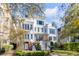 Beautiful three-story home with large windows and a well-manicured lawn in a suburban neighborhood at 172 Mary Ellen Dr, Charleston, SC 29403
