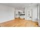 Open-concept kitchen with white cabinets, chandelier, island, and hardwood floors at 172 Mary Ellen Dr, Charleston, SC 29403