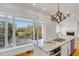 Granite island and chandelier enhance this kitchen's design, with views of the outdoors at 172 Mary Ellen Dr, Charleston, SC 29403