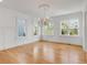 Bright living room featuring classic chandelier, detailed wall trim and large windows at 172 Mary Ellen Dr, Charleston, SC 29403