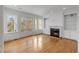 Bright living room with hardwood floors, fireplace, built-in shelving, and large windows at 172 Mary Ellen Dr, Charleston, SC 29403