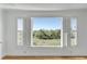 Large window with plantation shutters provides a scenic view of lush greenery and blue skies from inside at 172 Mary Ellen Dr, Charleston, SC 29403